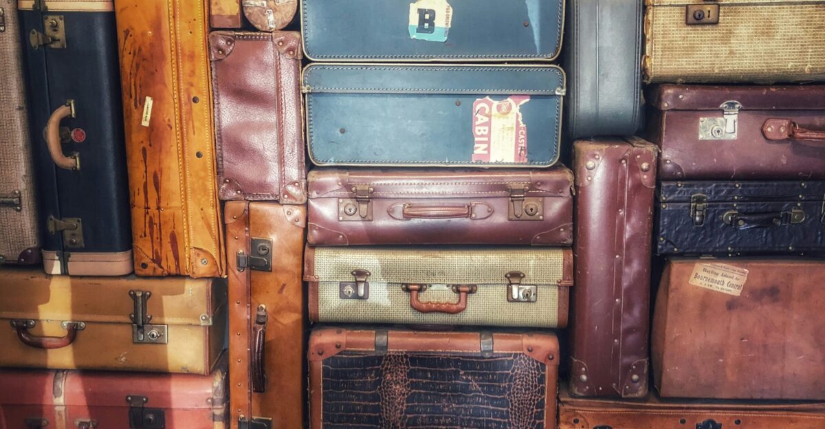 low light photography of stacked luggage