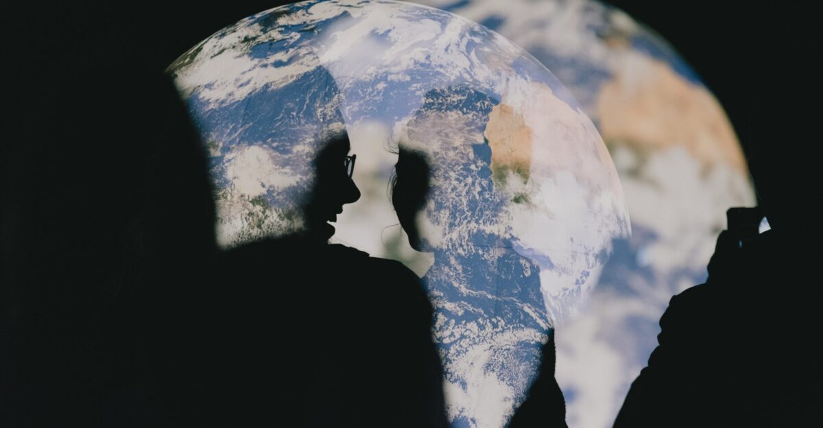 Silhouette of person observing images of earth