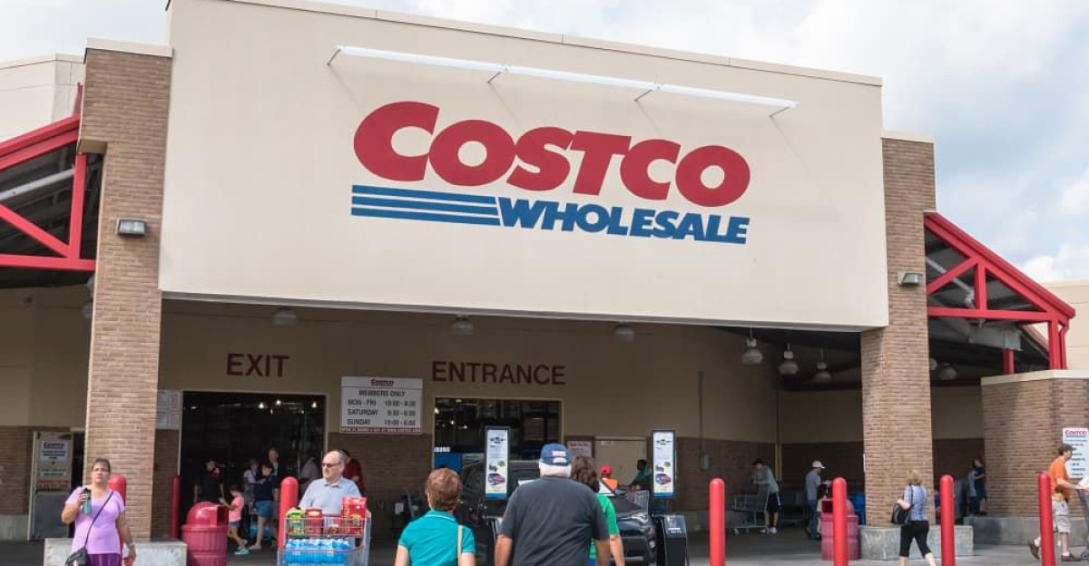 Customers walk in and exit at Costco entrance storefront Costco Wholesale Corporation is largest membership-only warehouse club in US It has 705 warehouses worldwide by Vickie Worsham