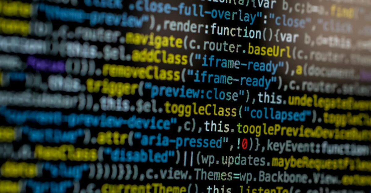 An extreme close-up of colorful programming code on a computer screen showcasing development and software debugging