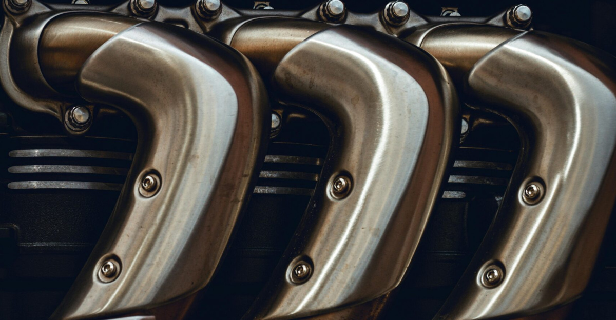Detailed look at polished metal engine exhaust pipes showing craftsmanship in technology.