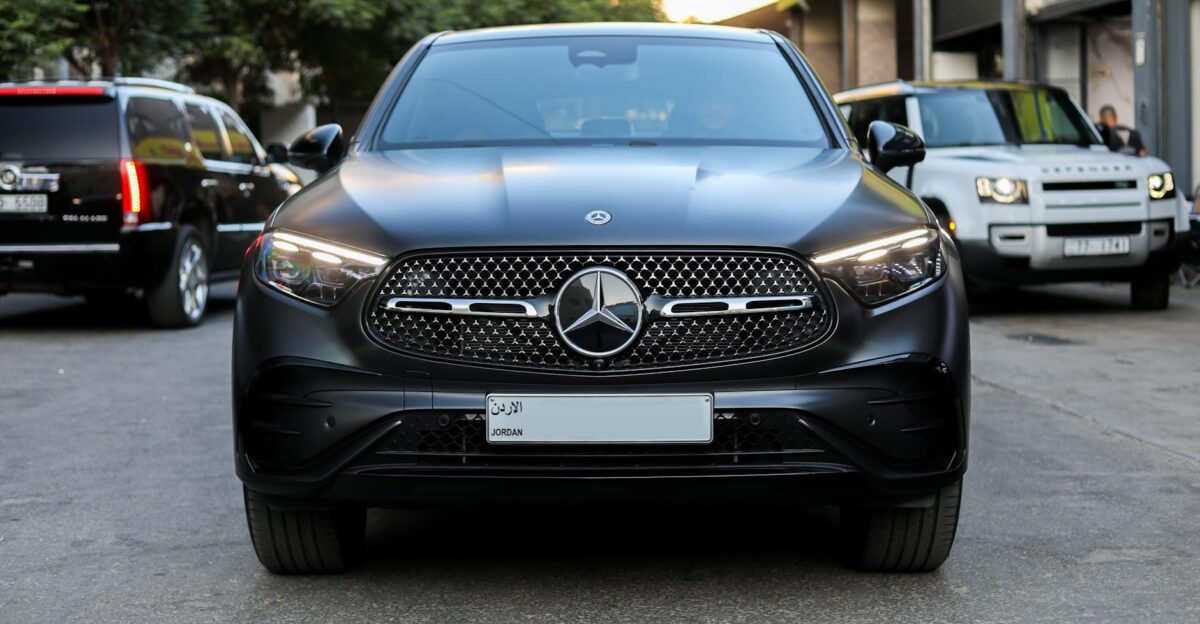 Front view of a sleek Mercedes-Benz SUV in a city setting showcasing luxury in Amman Jordan