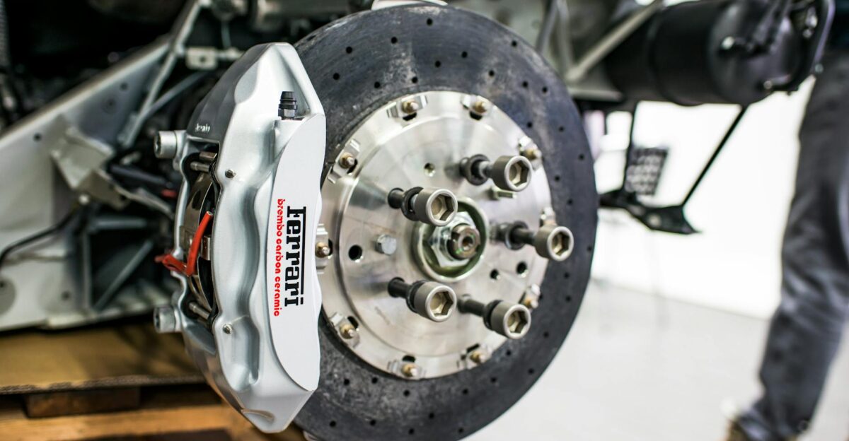 Detailed view of disc brake and caliper on a high-performance car emphasizing precision and technology