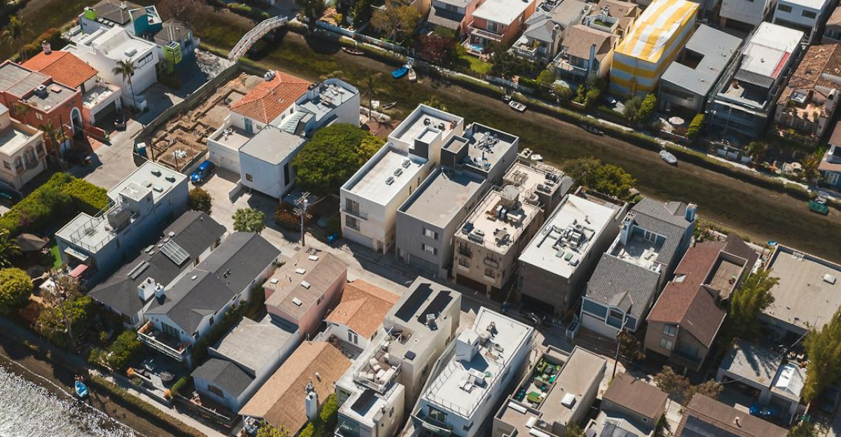 A scenic aerial shot showcasing a residential neighborhood with a canal running through it