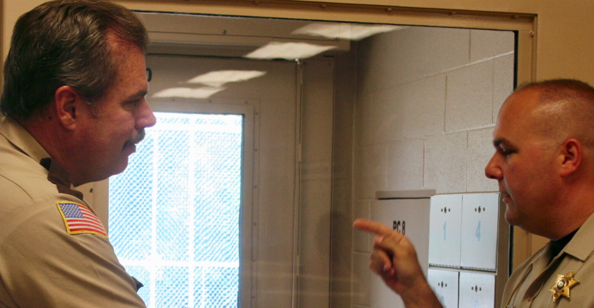 Two sheriff's department officers talk inside a detention center jail in the United States