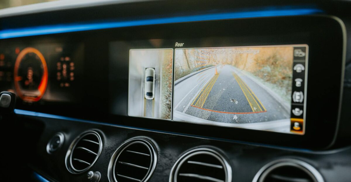 Close-up of a car dashboard showcasing a rear-view camera display and modern electronics