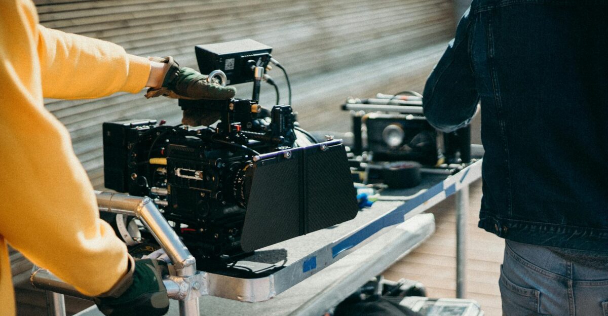 Close-up view of professional film equipment on a movie set with crew members preparing for filming