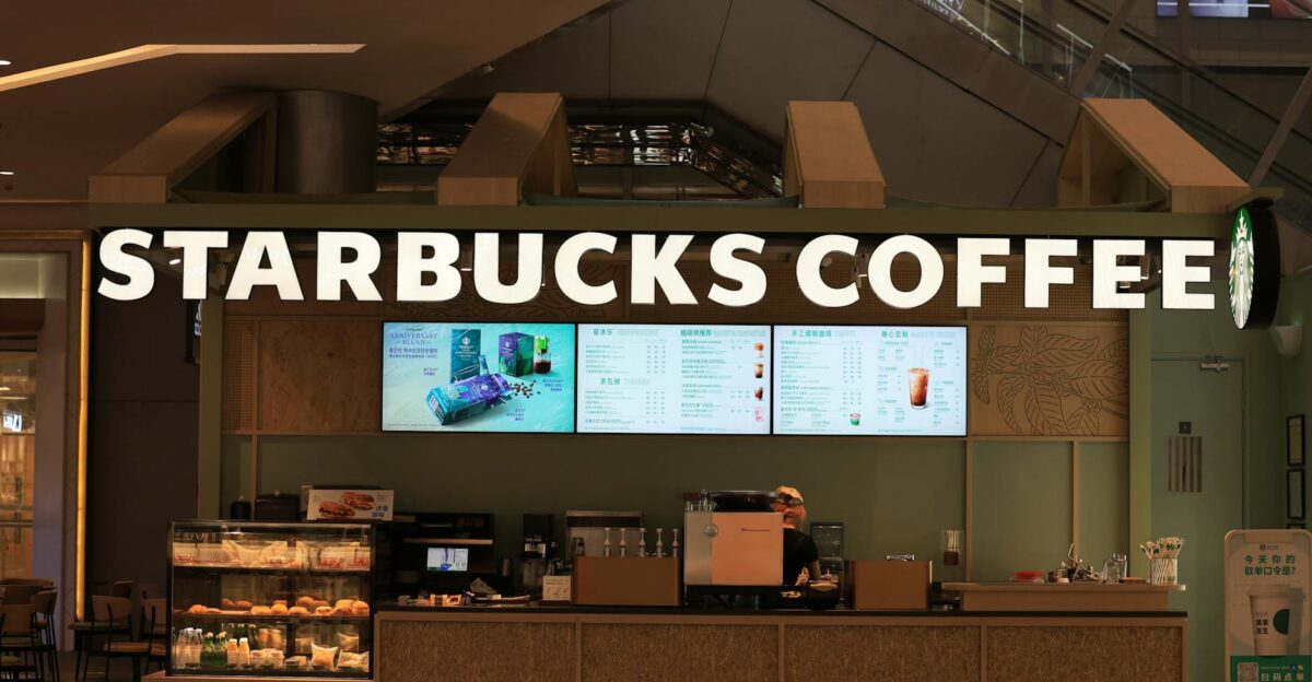 Interior view of a Starbucks Coffee shop with menu displays and counter setup