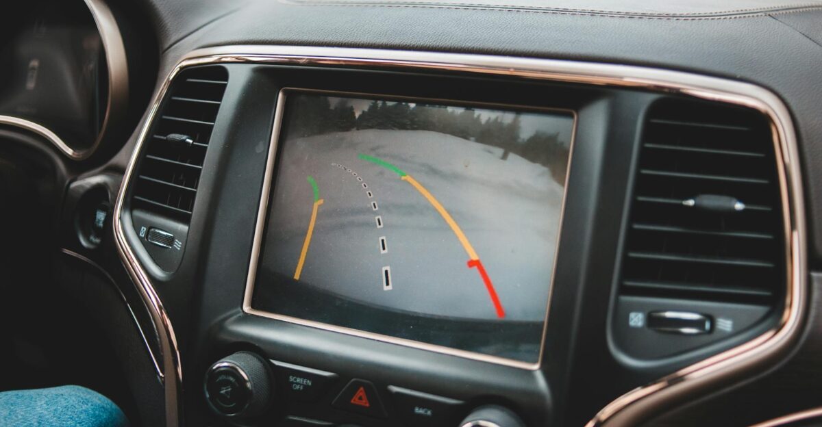 Close-up of a car s dashboard showing a rearview camera display for parking assistance