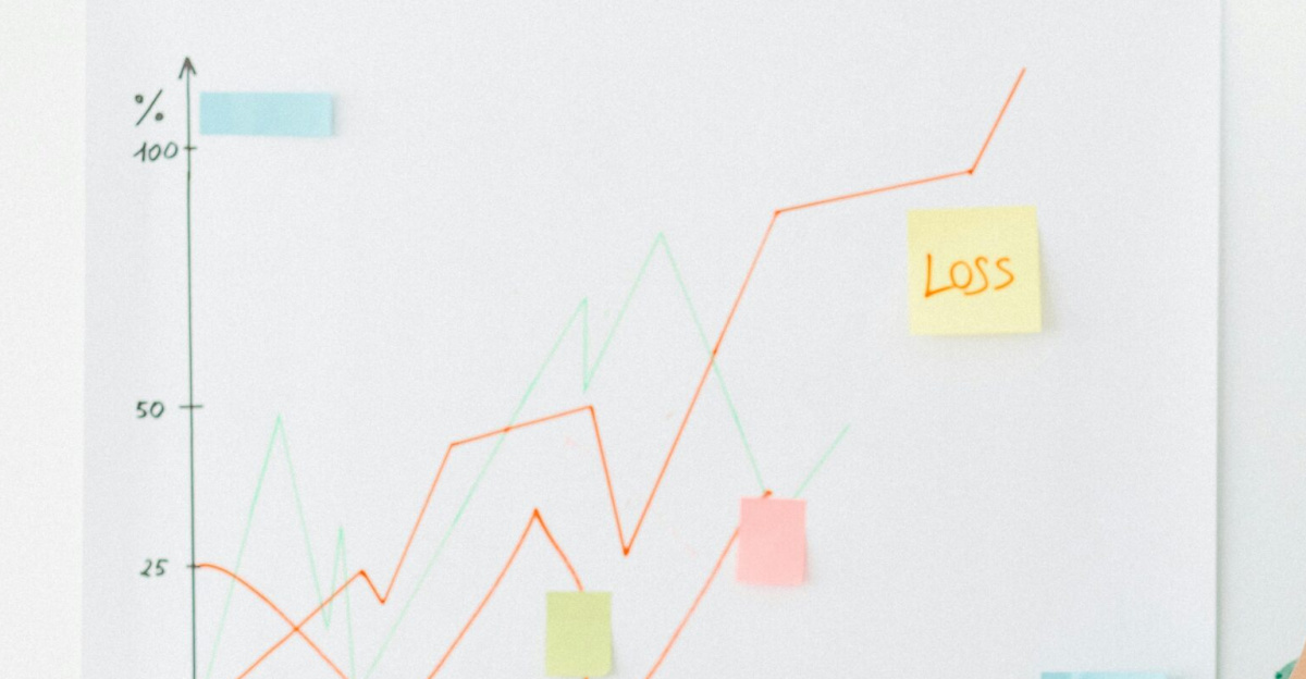 Businesswoman analyzing financial chart with loss noted, expressing stress.