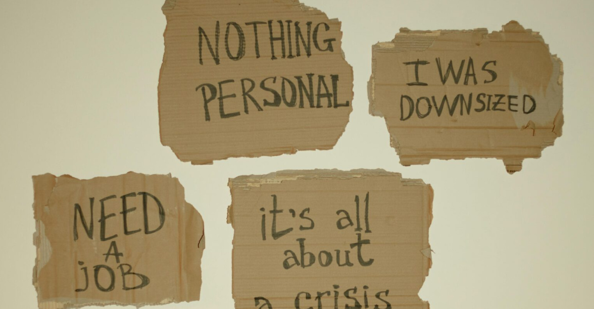 Cardboard signs convey job loss and economic crisis message, ideal for articles on unemployment.