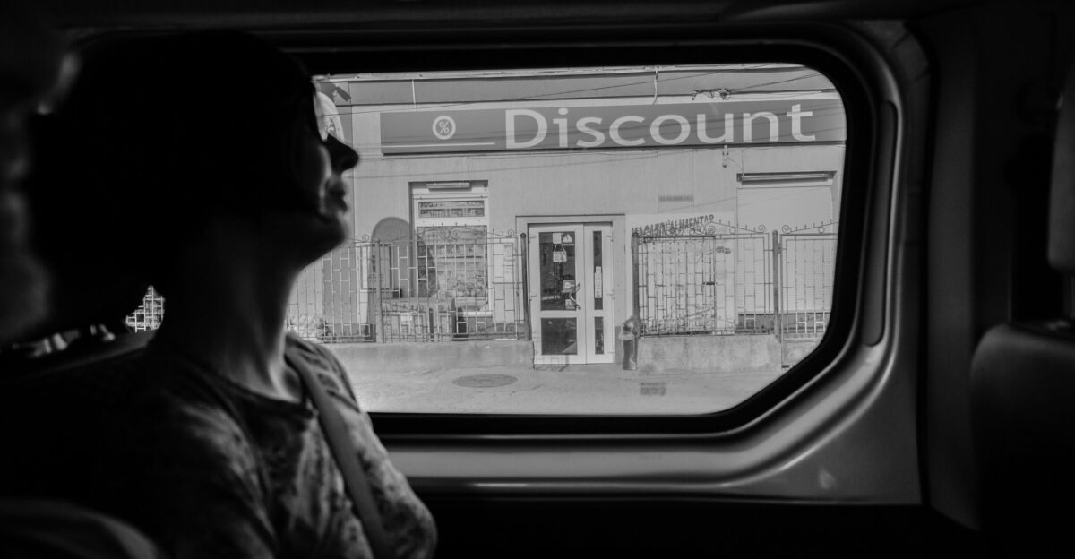 greyscale photography of woman inside vehicle
