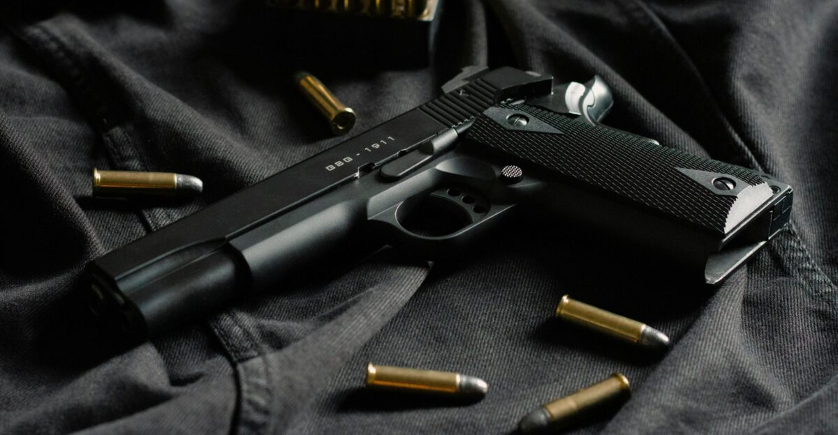 black semi automatic pistol on black textile