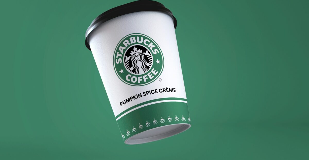 a starbucks coffee cup flying through the air