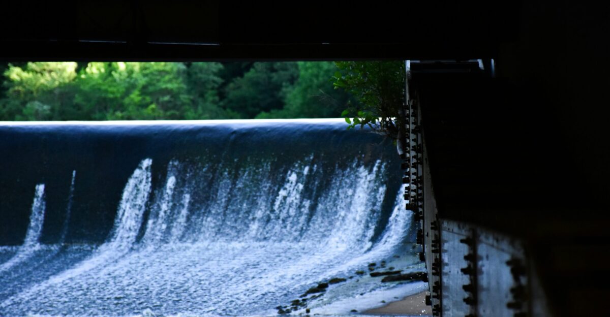 a large waterfall with trees in the background