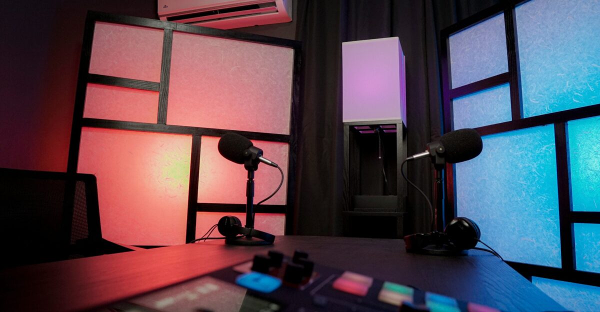 a desk with a lamp and a window