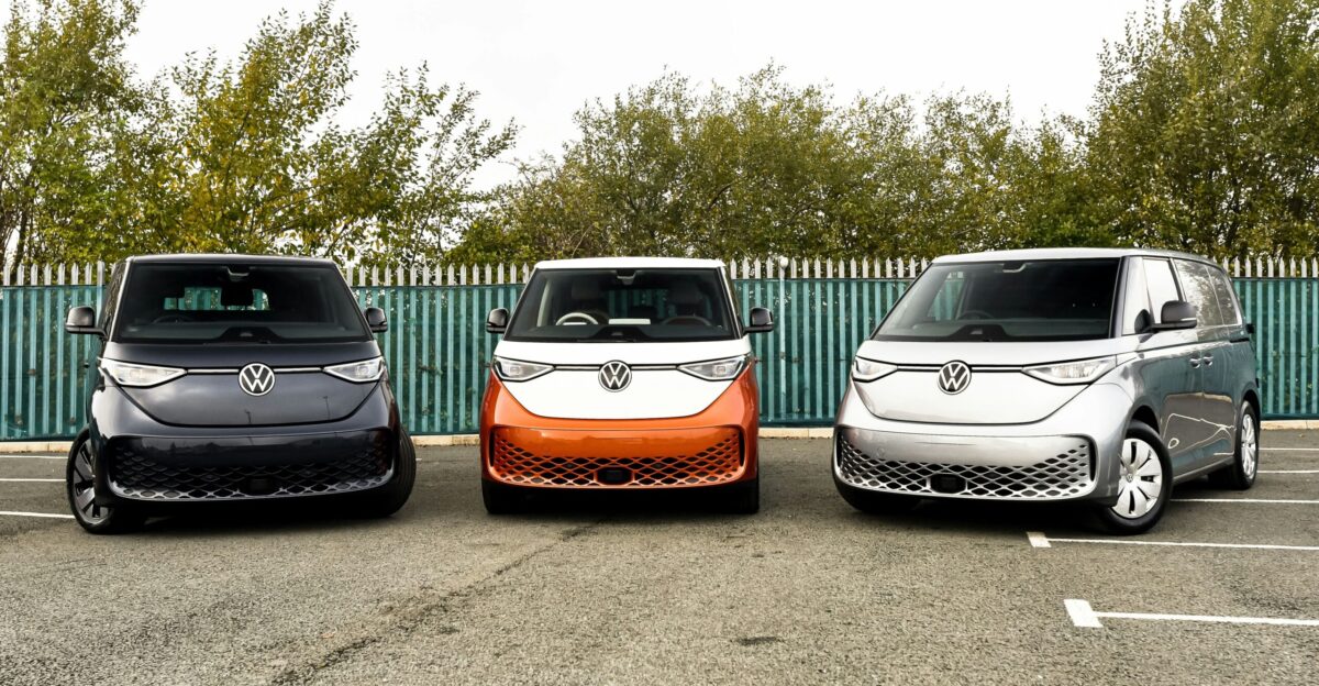 three electric vehicles parked in a parking lot