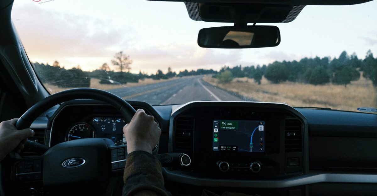 a person driving a truck on a rural road