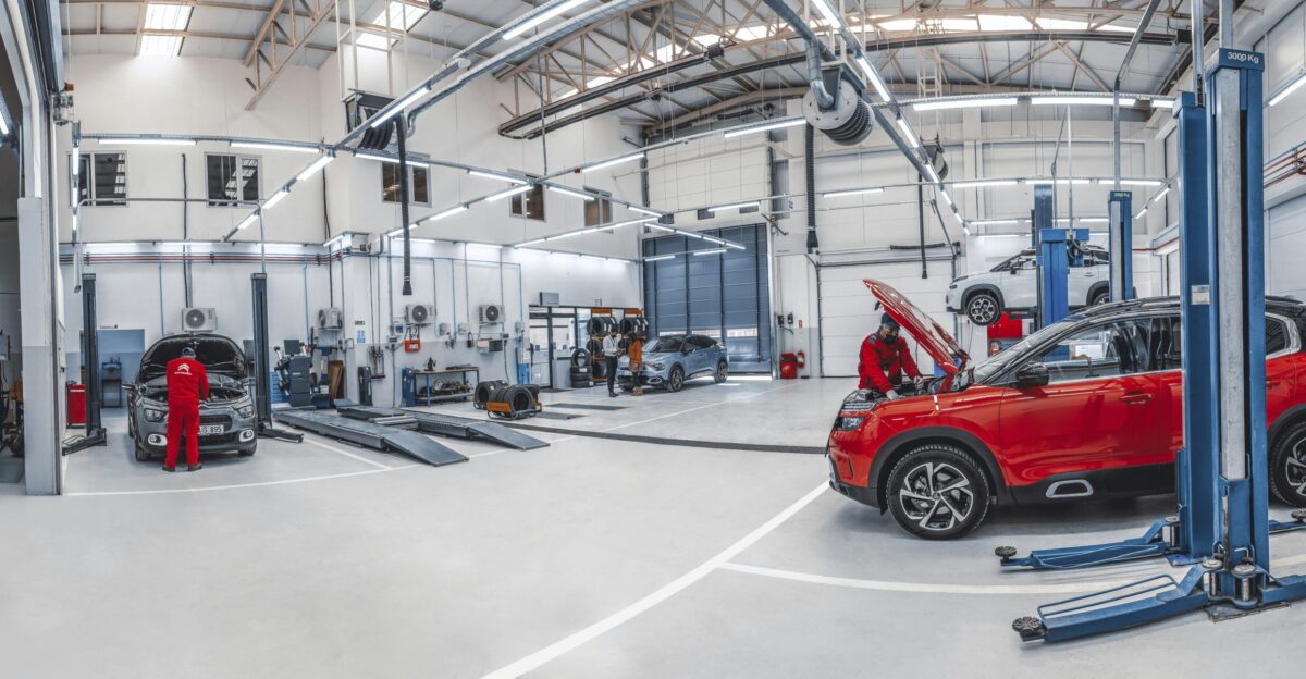 A red car is parked in a garage