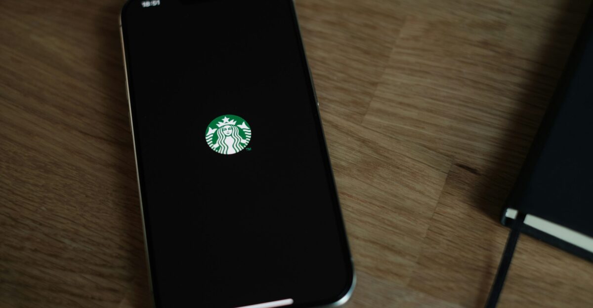 A cell phone with a starbucks sticker on it