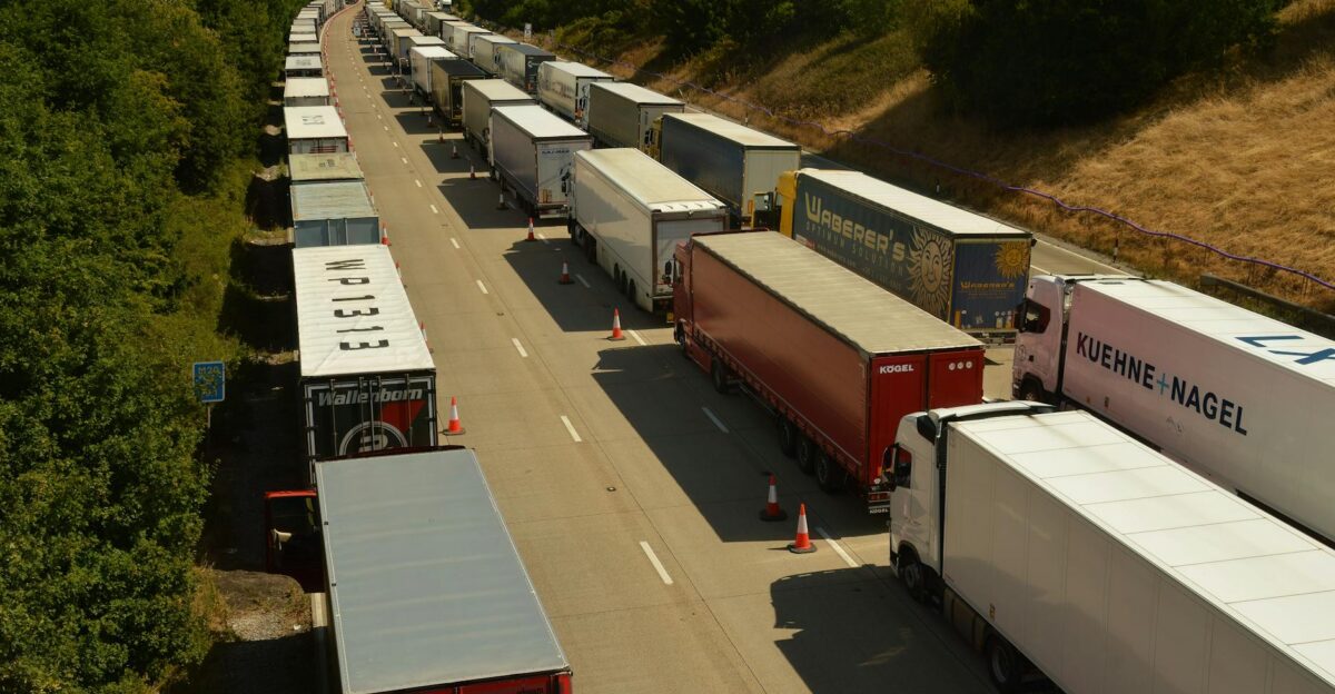 Drone shot capturing traffic jam of trailer trucks on a highway in England