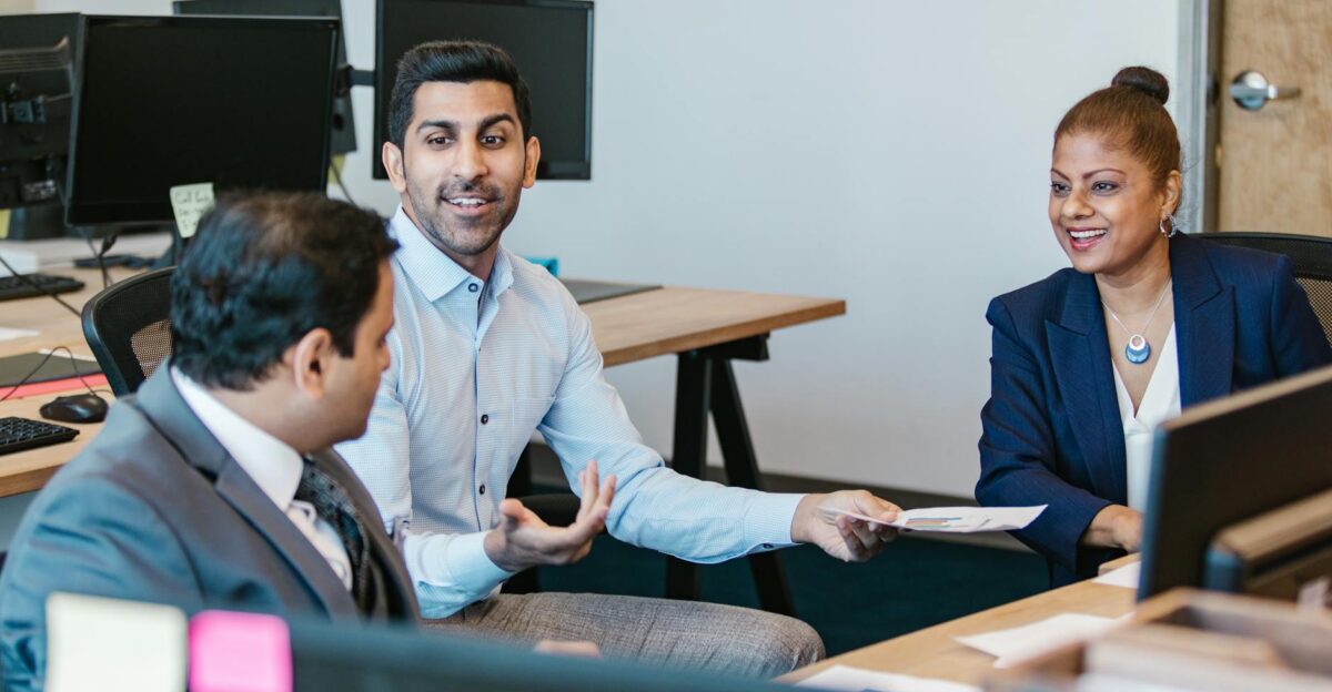 Colleagues engaging in a productive discussion in a modern office setting