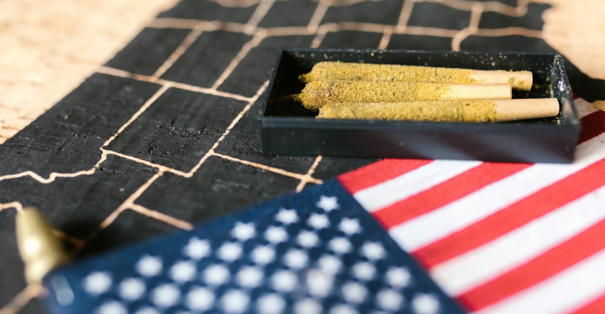 Cannabis joints in a tray with an American flag on a map background