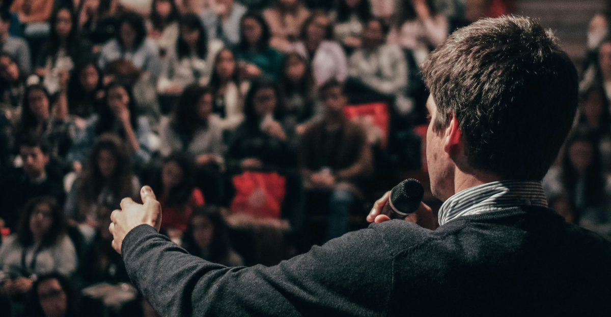 man speaking in front of crowd