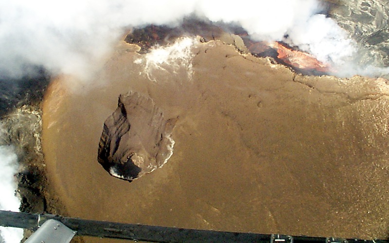 Nearly vertical view into a newly formed collapse pit Puka Nui on the south flank of Pu u O o The pit is 50 m in diameter at the surface and about 50 m deep tapering to a shaft of uncertain depth